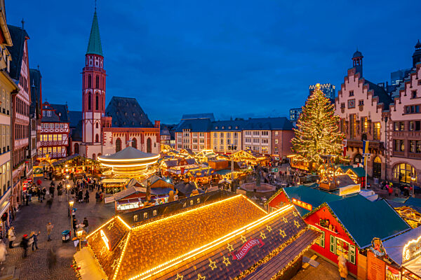 View of carousel and stalls on Christmas Market stalls at dusk, Roemerberg Square, Frankfurt am Main at dawn, Hesse, Germany, Europe