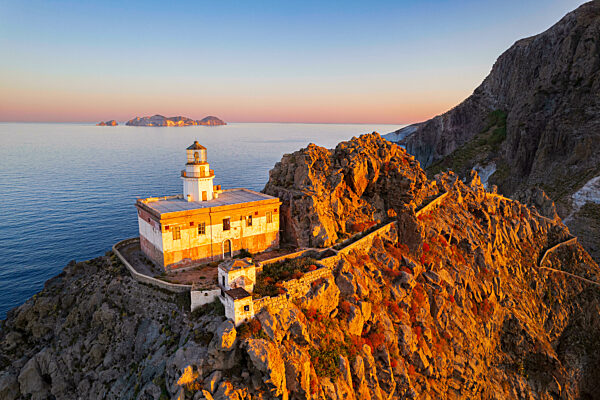 Aerial view of Punta della Guardia lighthouse on top of a cliff in the island of Ponza lit from sunrise, Ponza island, Pontine islands, Mediterranean sea, Latium, Central Italy, Italy, Europe