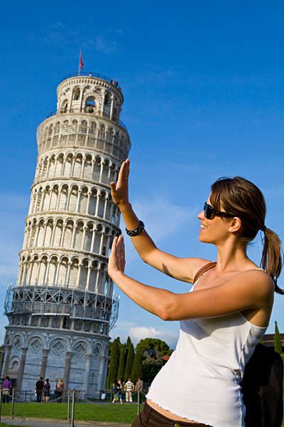 Young woman posing for photo with the Leaning Tower of Pisa, Pisa, UNESCO World Heritage Site, Tuscany, Italy, Europe