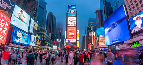 View of neon lights in Times Square at dusk, New York City, United States of America, North America