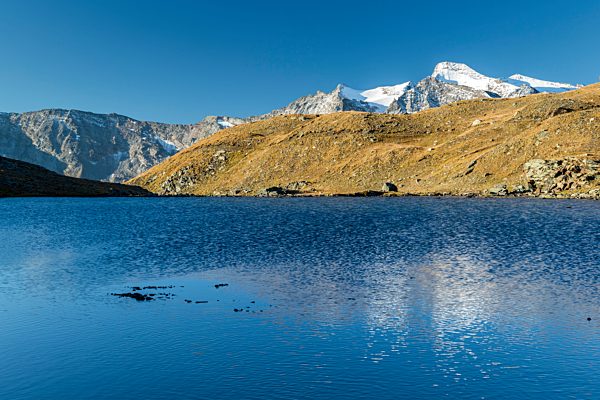Sunrise and reflections on Aiguille Rousse, Gran Paradiso National Park, Alpi Graie (Graian Alps), Italy, Europe
