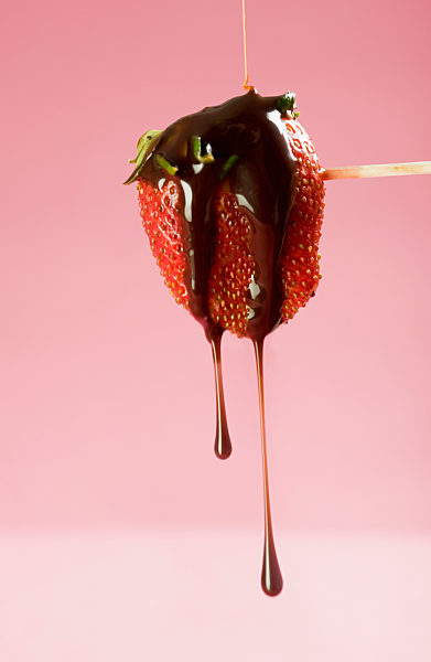 Close-up of a chocolate dipped strawberry on a skewer
