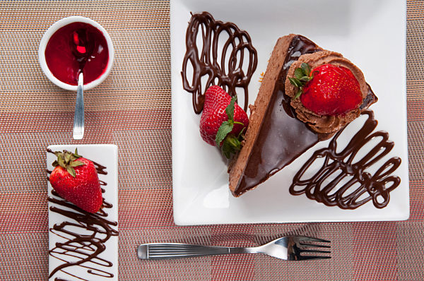 Chocolate mousse cake served with strawberries