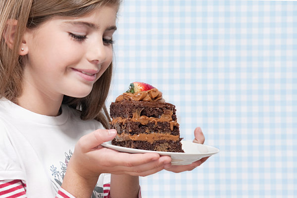 Girl holding a plate of chocolate pastry