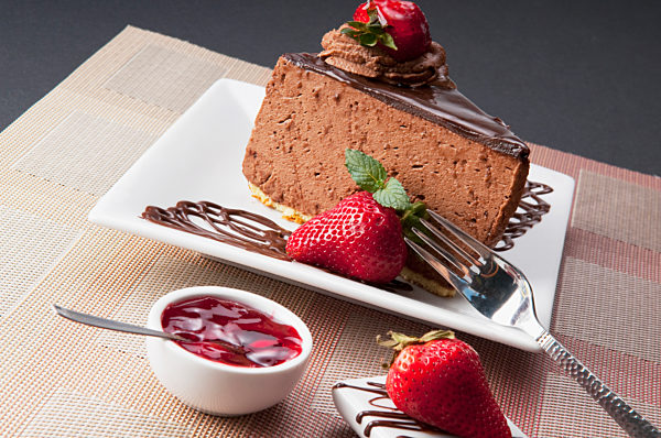 Chocolate mousse cake served with strawberries