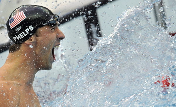 Michael Phelps from the USA celebrates after placing first in the men's 100m...