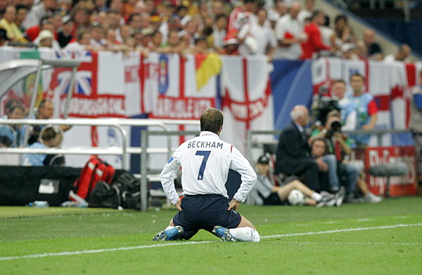 David Beckham from England knees on the pitch before substitution during the...