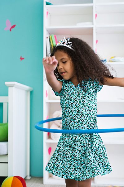 Little girl playing with plastic hoop