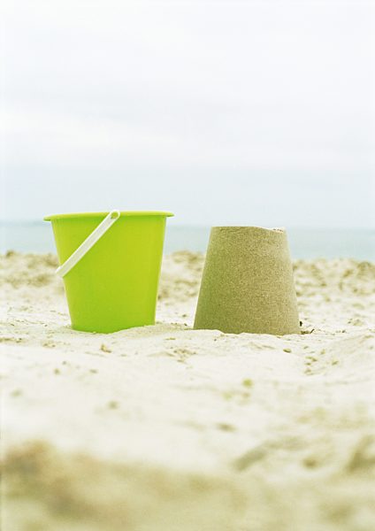 Bucket and molded sand on beach
