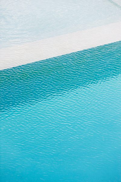 Swimming pool deep end separated from shallow pool by ledge