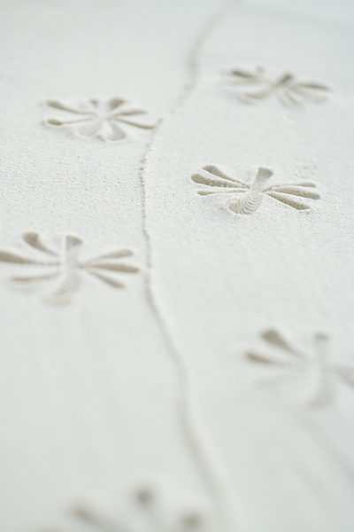 Flower pattern printed into sand, close-up
