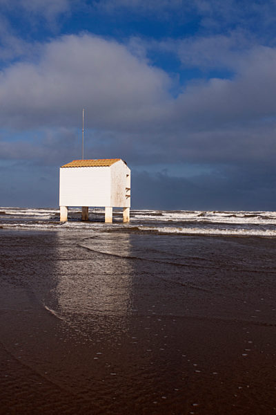Stilt building on beach during high tide