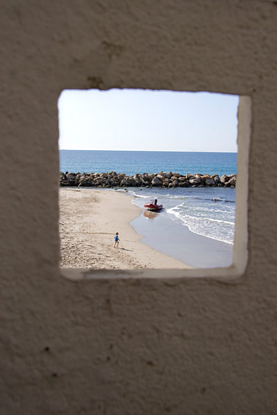 View of beach and ocean through window