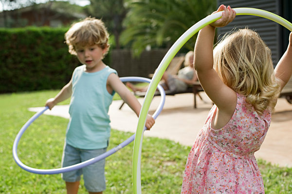 Children playing with plastic hoops outdoors
