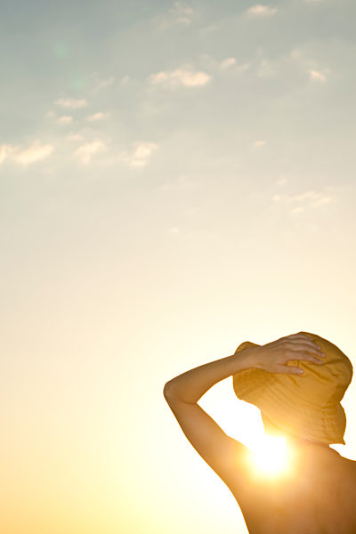 Woman outdoors silhouetted against setting sun
