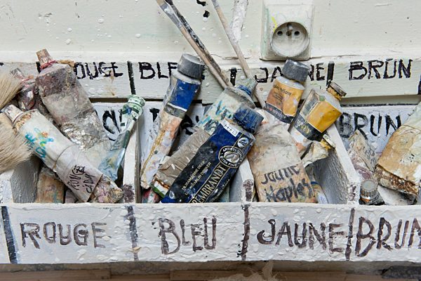 Paint tubes sorted by color in box