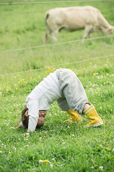 Child playing in grass on farm