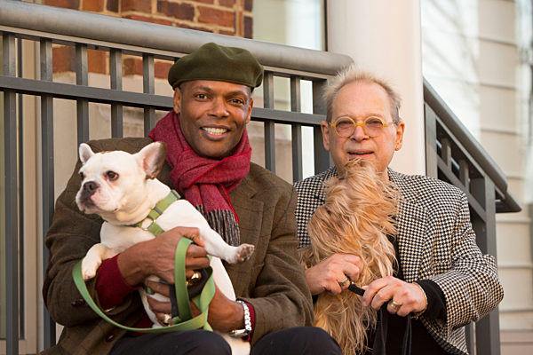 Portrait of men sitting on stoop holding dogs, Portrait der Maenner sitzen auf Stoop Halte Hunde