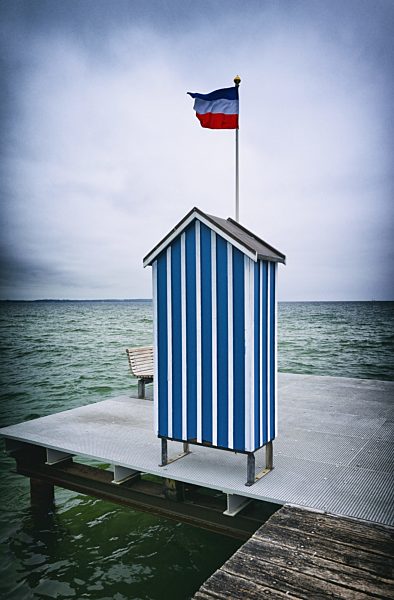 Pier ocean changing cabin blue stripped flagpole