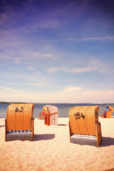 Old-fashioned summer hooded beach chairs sunshine