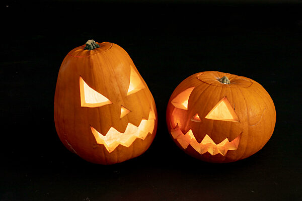 Composition of halloween jack o lanterns and copy space on black background