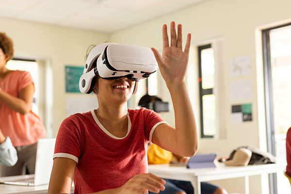 In high school, teenager using VR headset and interacting with virtual environment. Technology, innovation, education, learning, virtual reality, high high school