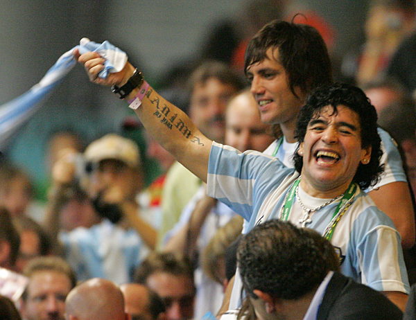 Former Argentinian soccer legend Diego Armando Maradona celebrates after the...